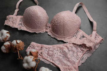 Sticker - Elegant light pink women's underwear and cotton flowers on grey background