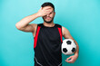 Young football player Brazilian man isolated on blue background covering eyes by hands. Do not want to see something