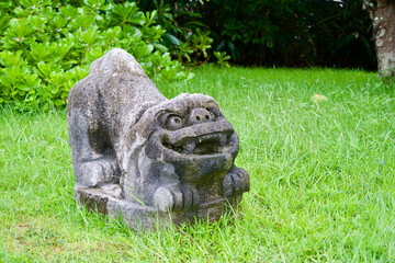 Poster - The statue of Shisa in the grass.