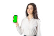 © Maxim Morales - Woman wearing a white shirt holding a smartphone (with green screen) looking at camera. Isolated on white background. 20-22 years old. White european woman.