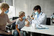 © Prostock-studio - Teen boy getting vaccinated against coronavirus at clinic