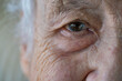 © berna_namoglu - closeup wrinkled face and eye of an old senior woman or man