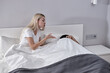 © alfa27 - Blonde Angry Female Screaming At Sleeping Lazy Man On Bed At Home, Family Problems Concept. Married Couple With Problems Having Disagreement In Bed. Male Is Ignoring, Doesn't Talk