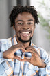 © Svyatoslav Lypynskyy - Handsome Guy in Plaid Casual Shirt Shows Heart Gesture by his Fingers. Dark Skin Male Model Makes Heart Figure by his Hands. Fell in love. Close-up.