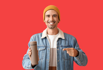 Sticker - Handsome man with thermos on color background