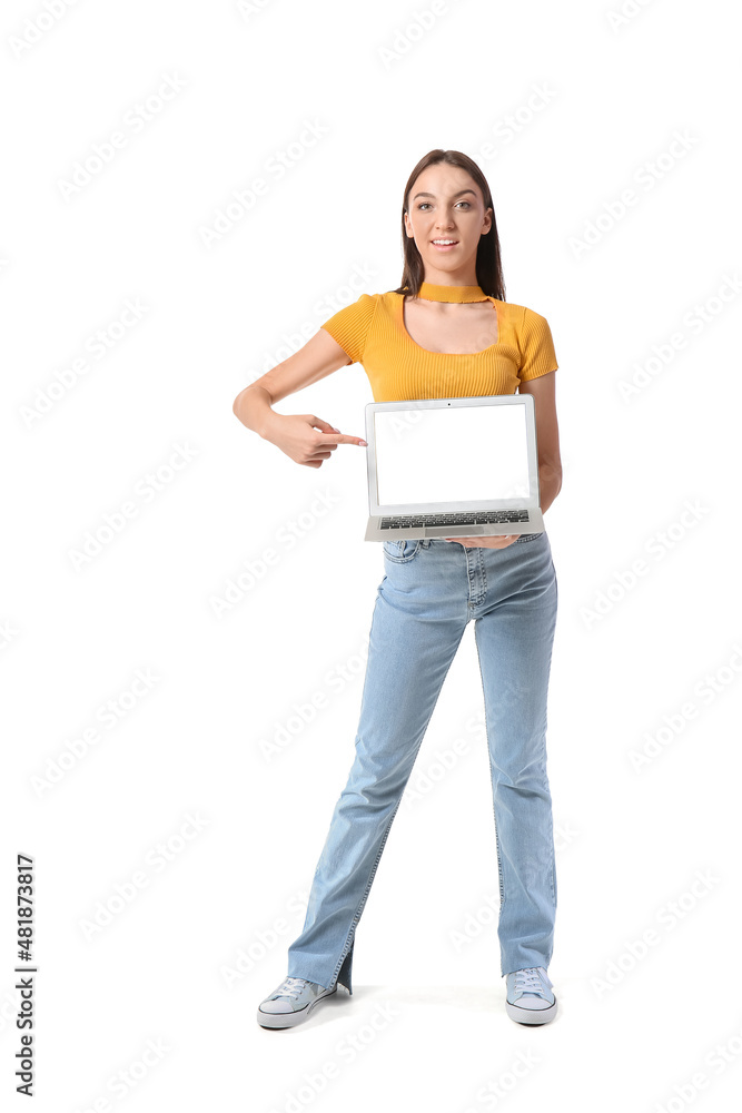 Pretty brunette woman pointing at laptop on white background