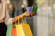 Unrecognizable Black Female Holding Three Credit Cards And Shopping Bags