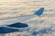 Wing of an airplane above the clouds - Airplane wing in flight