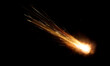 texture of a falling comet with sparks, smoke and a trail of particles, isolated on a black background