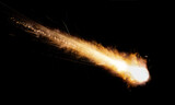 texture of a falling comet with sparks, smoke and a trail of particles, isolated on a black background