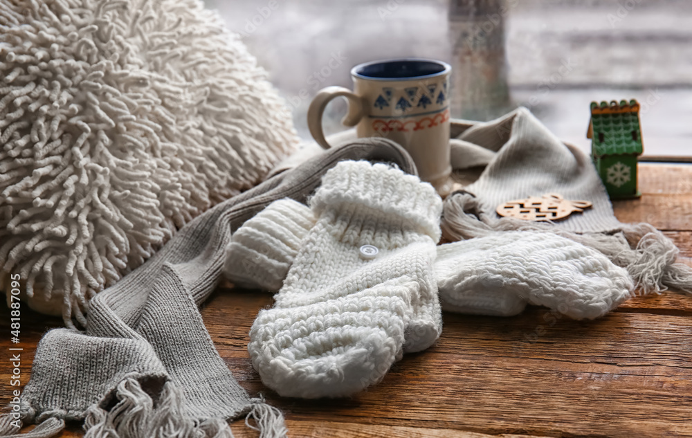 Warm gloves and scarf on windowsill