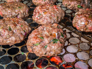 homemade hamburger cooking on the grill