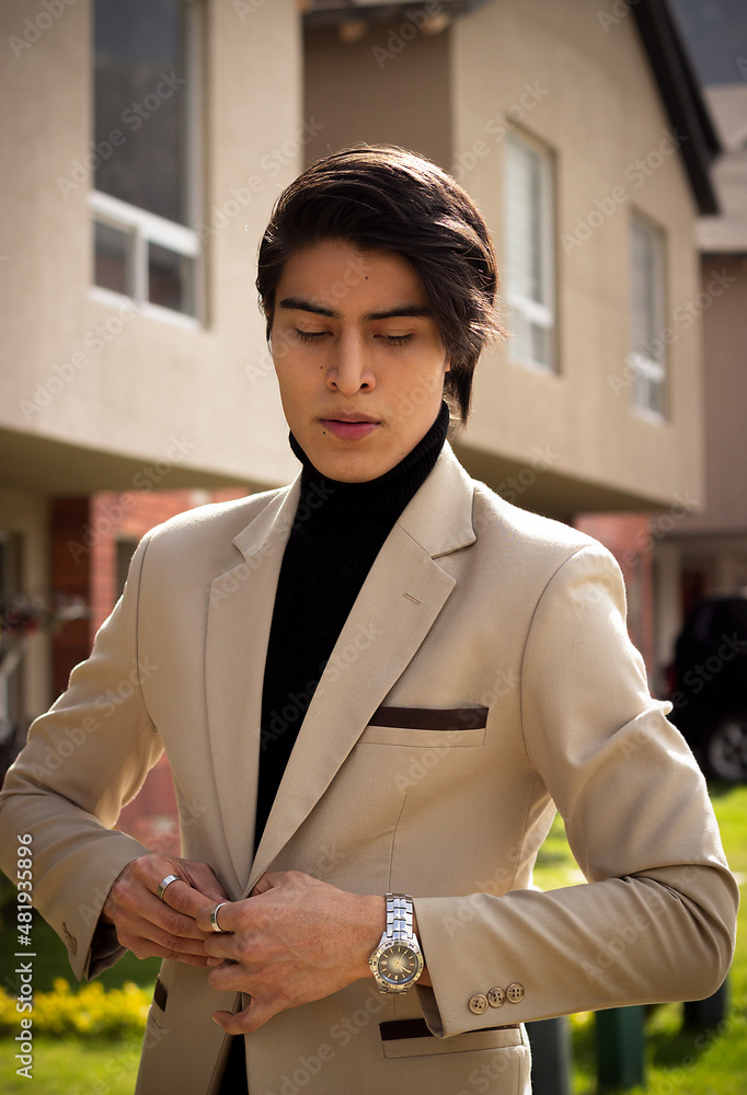 Handsome latin american young man in beige suit and black turtleneck sweater Stock Photo Adobe Stock