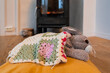 a rabbit toy pet resting in front of the fireplace in winter