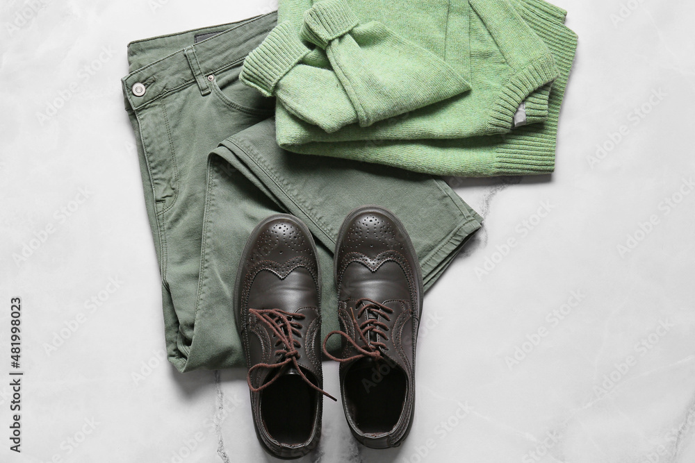 Male sweater, pants and shoes on light background