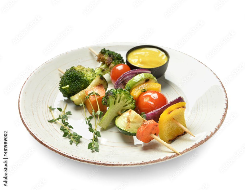 Plate with tasty vegetable skewers on white background