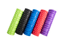 Multicolored foam rollers on white background. Gym fitness equipment. Self body care massage and pain relief. Top view