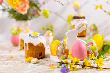 Wall Mural - Easter still life with colorful Easter cakes, Easter eggs on rabbit dessert plate. Traditional Easter treat