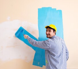 Wall Mural - Painter man painting the wall at home