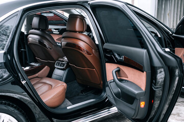 Premium car interior, brown perforated leather, decorative inserts the  interior, painted in orange wood color, leather steering wheel.