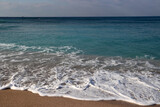 Fototapeta Niebo - Clear blue sea water close up photo. Calm sea, blue sky,  tranquil scene. Warm day on the beach. 