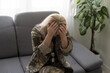 © Angelov - depressed lonely woman in military uniform at home