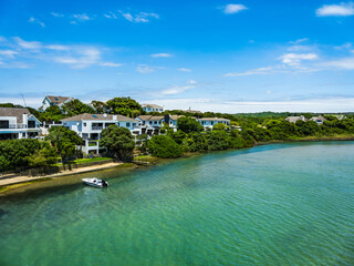 Wall Mural - A Boat and houses on the Kromrivier bank in Oyster Bay St Francis Bay South Africa