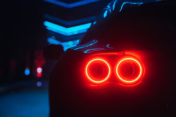 Sticker - Supercar led taillight at the night city street, rear view