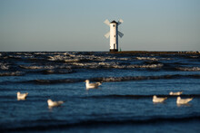 Seascape With Lighthouse Looks Like Windmill. Swinoujcie In Poland.