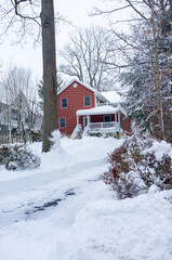 Wall Mural - Red suburban house and driveway after the snow storm in February