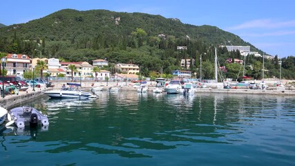 Wall Mural - Boats in port of Benitses resort village on Corfu Island, Greece, 4k