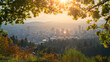 Portland Downtown and Mt Hood Framed with Maple leaves and other autumn foliage, Rising sun shining behind the leaves.