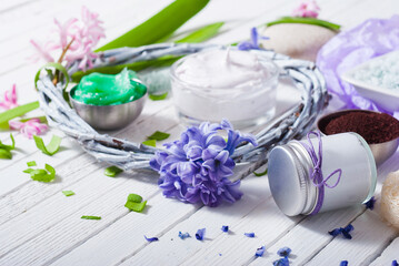 Wall Mural - cosmetic cream product samples with hyacinth flowers on white wooden background