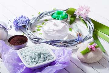 Wall Mural - cosmetic cream product samples with hyacinth flowers on white wooden background