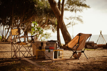 Wall Mural - compact camping set for two in warm light, beach side park