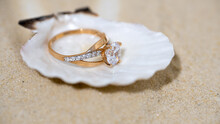 Beautiful Engagement Ring With A Diamond In A Sea Shell, A Shell With A Ring On The Sand, Sandy Beach