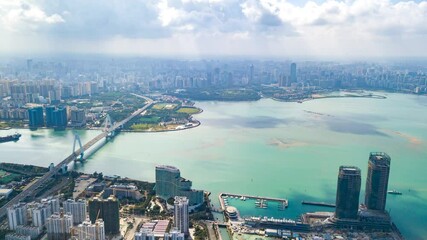 Wall Mural - Aerial Timelapse of Haikou Century Bridge and  Haikou City CBD Skyline in a Sunny Day, Hainan Free Trade Port, China.