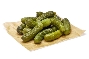 Wall Mural - Tasty Whole green cornichons on parchment paper isolated on a white background