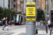 A Warning Sign Advising Pedestrians To Watch Out For Trams In George Street, Sydney,  Australia.