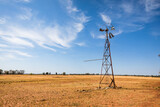 Fototapeta Na sufit - A broken down old water pump windmill on a rural farm in Outback Australia.