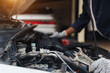 © A Stockphoto - Automobile mechanic repairman hands repairing a car engine automotive workshop with a wrench, car service and maintenance,Repair service.