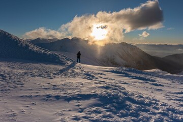 Wall Mural - beautiful winter views of the high tatra mountains with tourists, skiers and amazing states of natur