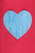 Empty heart with space for design, space for text. Heart symbol lying on red silk.