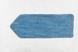 Empty denim arrow with space for design, space for text. Pointer lying on white decorated leather