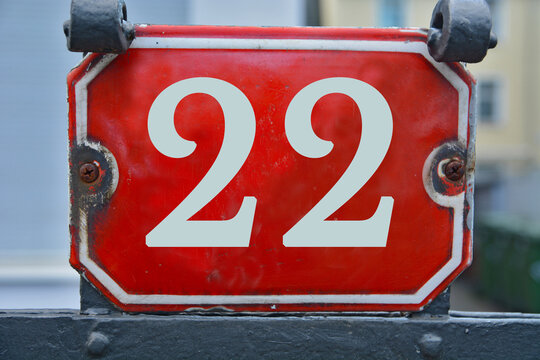 A red number plaque, showing the number twenty-two, 22