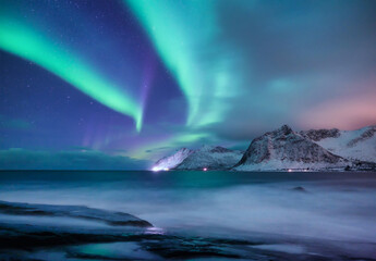 Wall Mural - Aurora borealis in Norway. Green northern lights. Night winter landscape with aurora. Natural background in Norway.