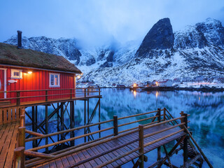 Canvas Print - View on the house in the Lofoten Islands, Norway. Landscape in winter time during blue hour. Mountains and water. Travel image.