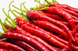 Red hot chili pepper isolated on a white background.
This pile of red chilies is commonly used as a raw material for spicy chili sauce.