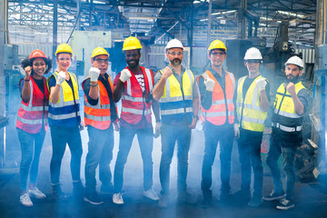 Team Workers and workers are standing in the factory. Group Staff Standing In Engineering Factory.