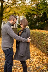 Wall Mural - Caring young european married couple in autumn park